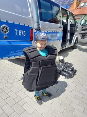 na zdjęciu widać dziecko w policyjnej kamizelce